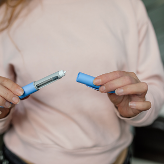 Adult preparing a GLP-1 medication injection, such as semaglutide, for weight loss or type 2 diabetes management.